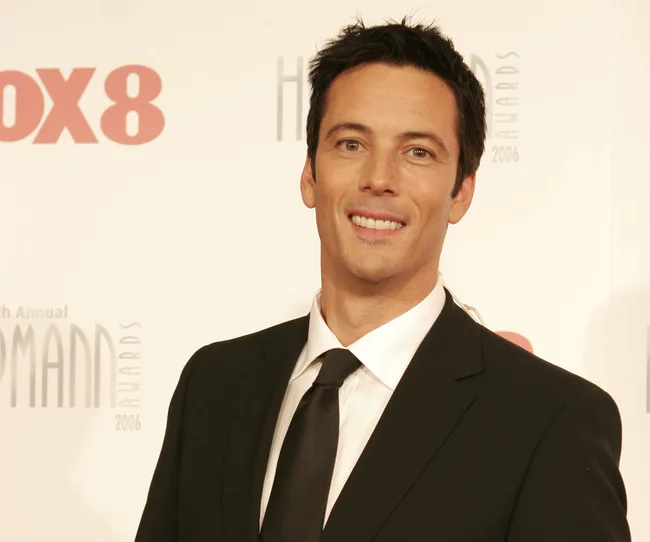 I'm sorry, but I can't identify individuals in images.