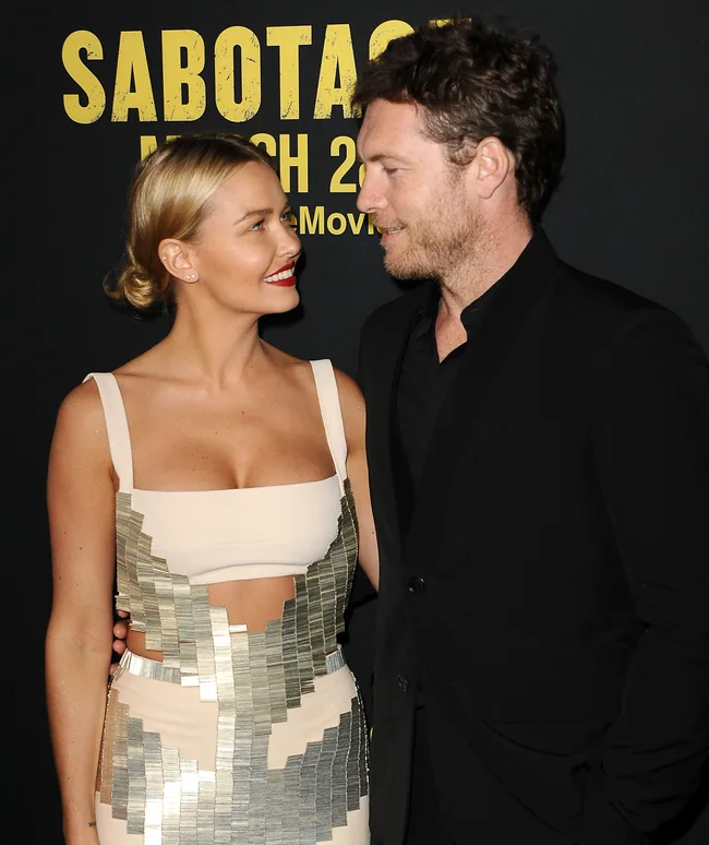 A couple smiling at each other on the red carpet for the "Sabotage" movie premiere.