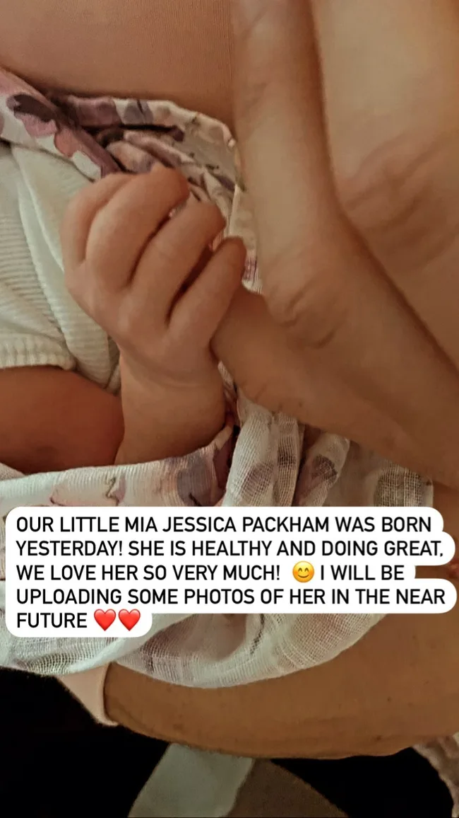 Newborn baby Mia Jessica Packham's hand holding an adult finger, with a birth announcement text overlay.