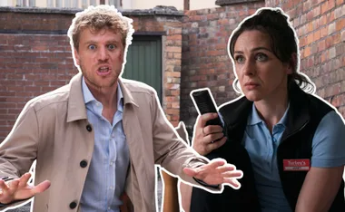 Man gesturing in beige coat, woman with "Janet" badge holding a device, both against brick backdrop.