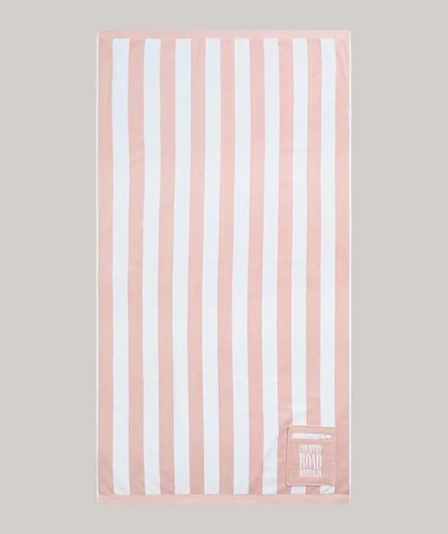 Striped beach towel with pink and white vertical lines, featuring a "Country Road Australia" patch.