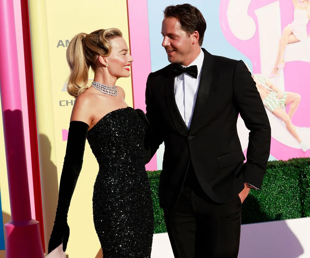 Margot Robbie in black sparkly sequin dress with long black gloves with husband Tom Ackerley