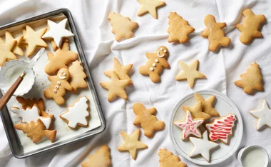 Assorted Christmas cookies shaped like stars, trees, and gingerbread men, some decorated with icing.