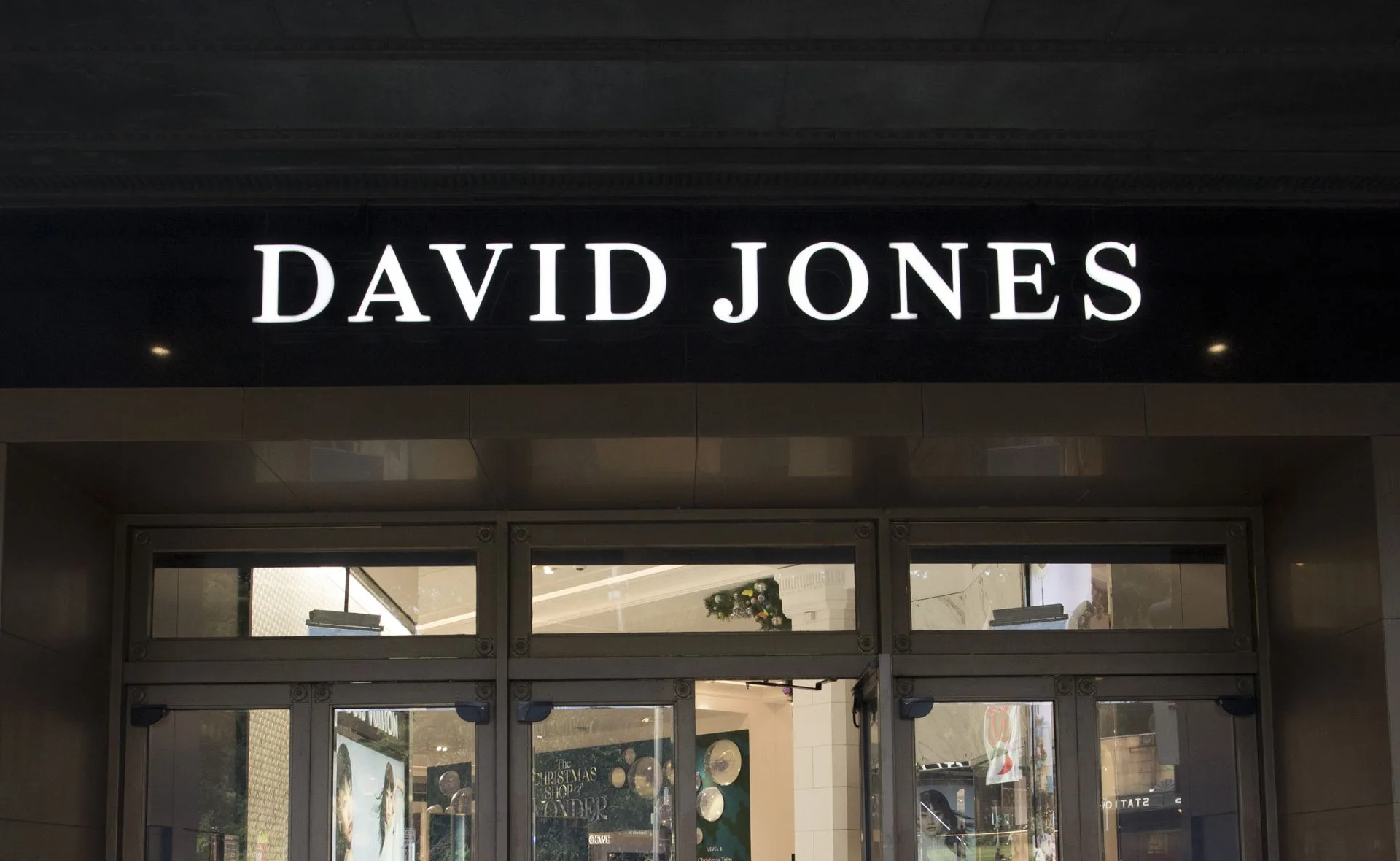 David Jones store entrance with illuminated sign above glass doors.