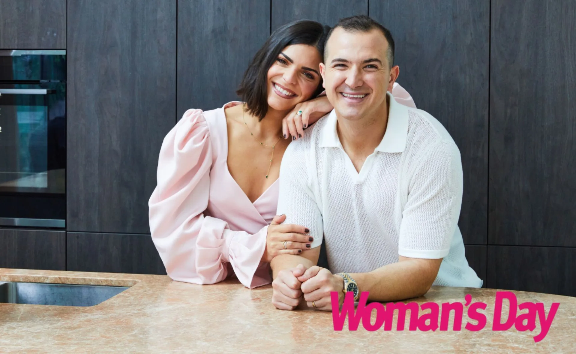 A couple smiling in a kitchen setting, with "Woman's Day" logo in the corner.