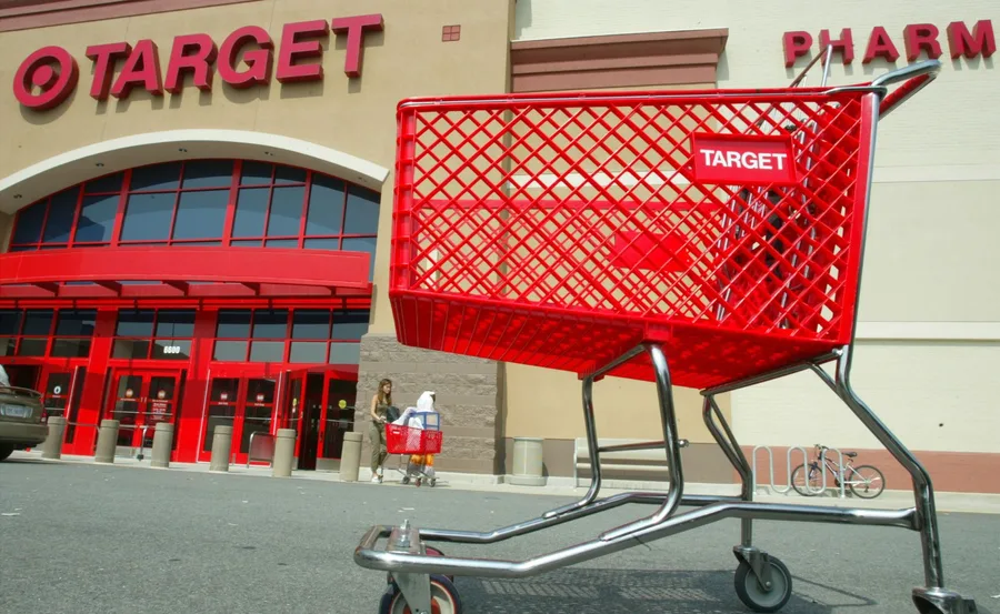 Red shopping cart in front of a Target store entrance.