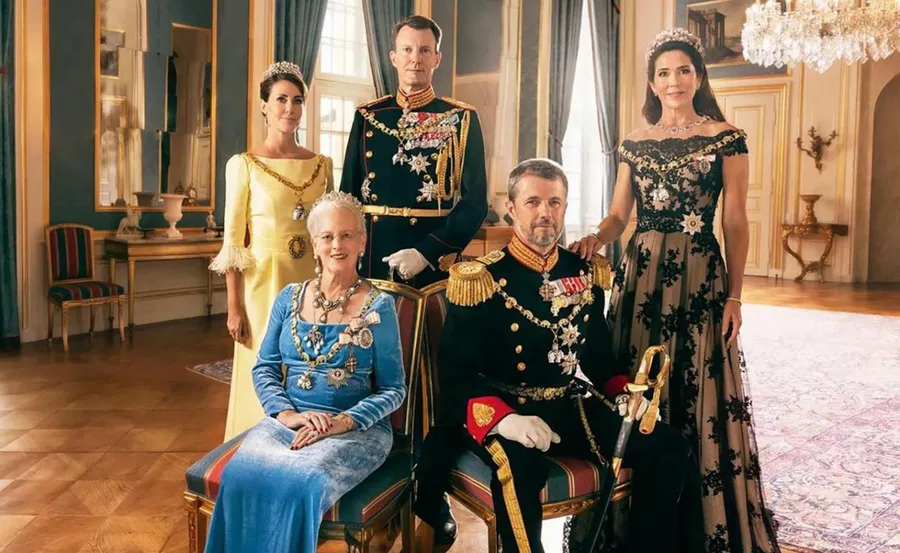 Danish royal family members in formal attire, seated and standing in an elegant room.