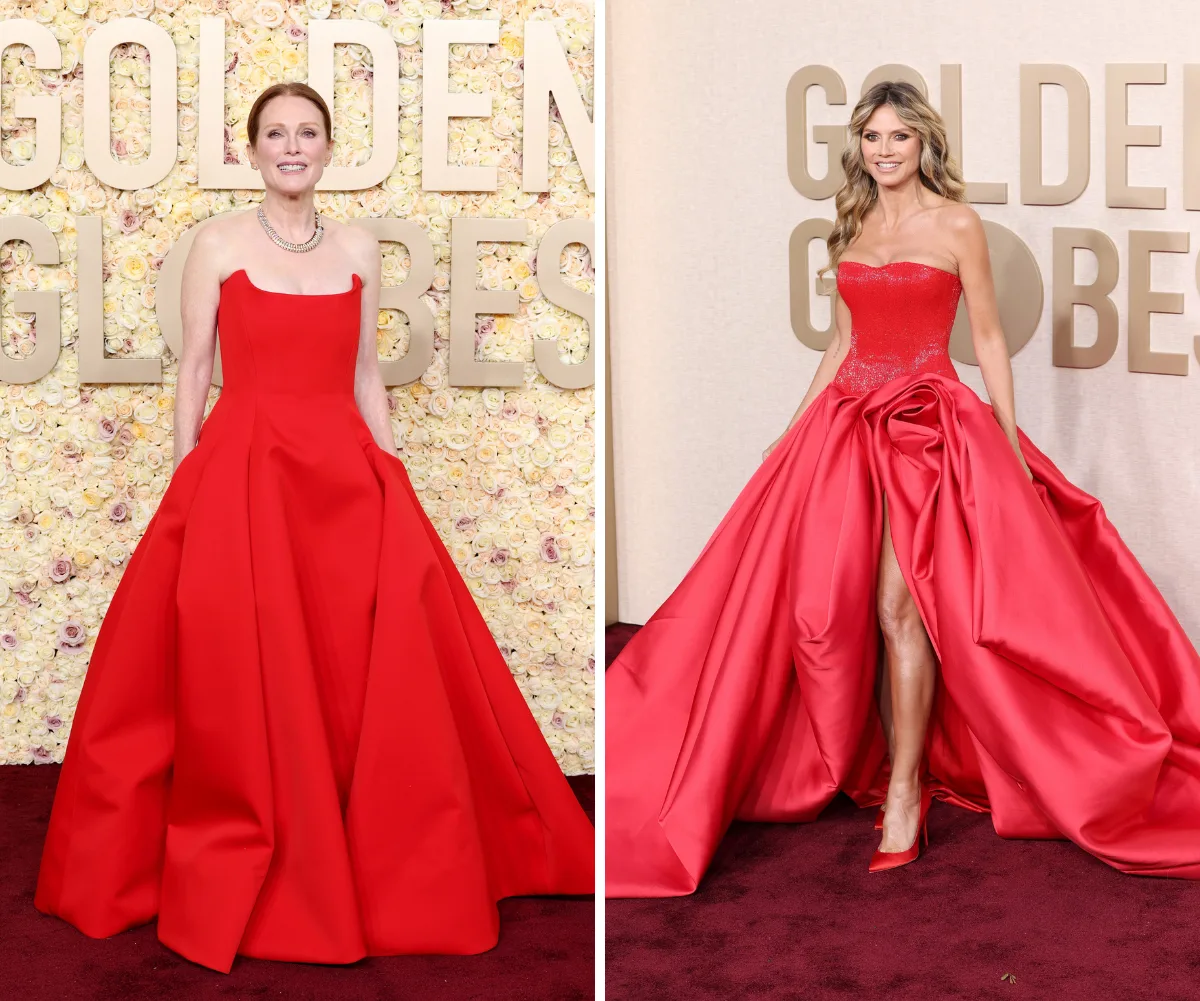 Two women in red gowns on a red carpet at an awards event, standing before a backdrop with gold letters.