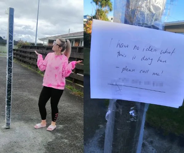 A woman in pink shrugs at a random pole in a driveway with a note saying, "I have no idea what this is doing here."