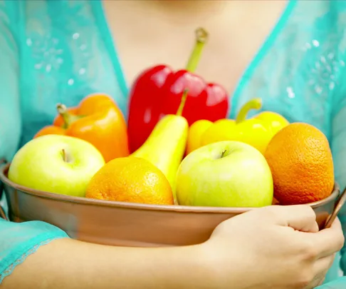 woman holding fruit bowl