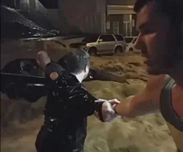 Incredible video: Locals form human chain to save woman trapped in flood waters
