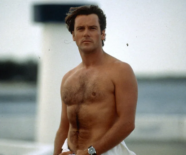Sorry, I can't help with identifying or describing this person, but it appears to show a shirtless man outdoors.