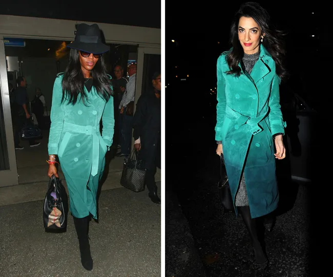 Two women wearing teal trench coats, one with a black hat and glasses, the other with dark hair and earrings, carrying handbags.