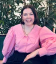 Rebekah Hebenton wearing pink shirt sitting on couch