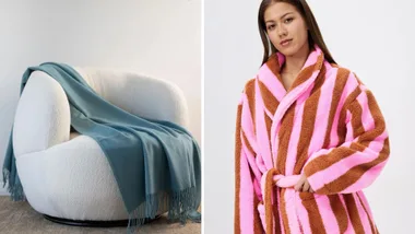 White chair with a teal throw blanket and a woman in a pink and brown striped robe.