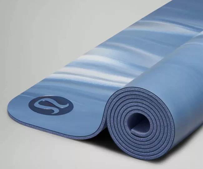 Blue and white marbled yoga mat partially rolled up, featuring the Lululemon logo.