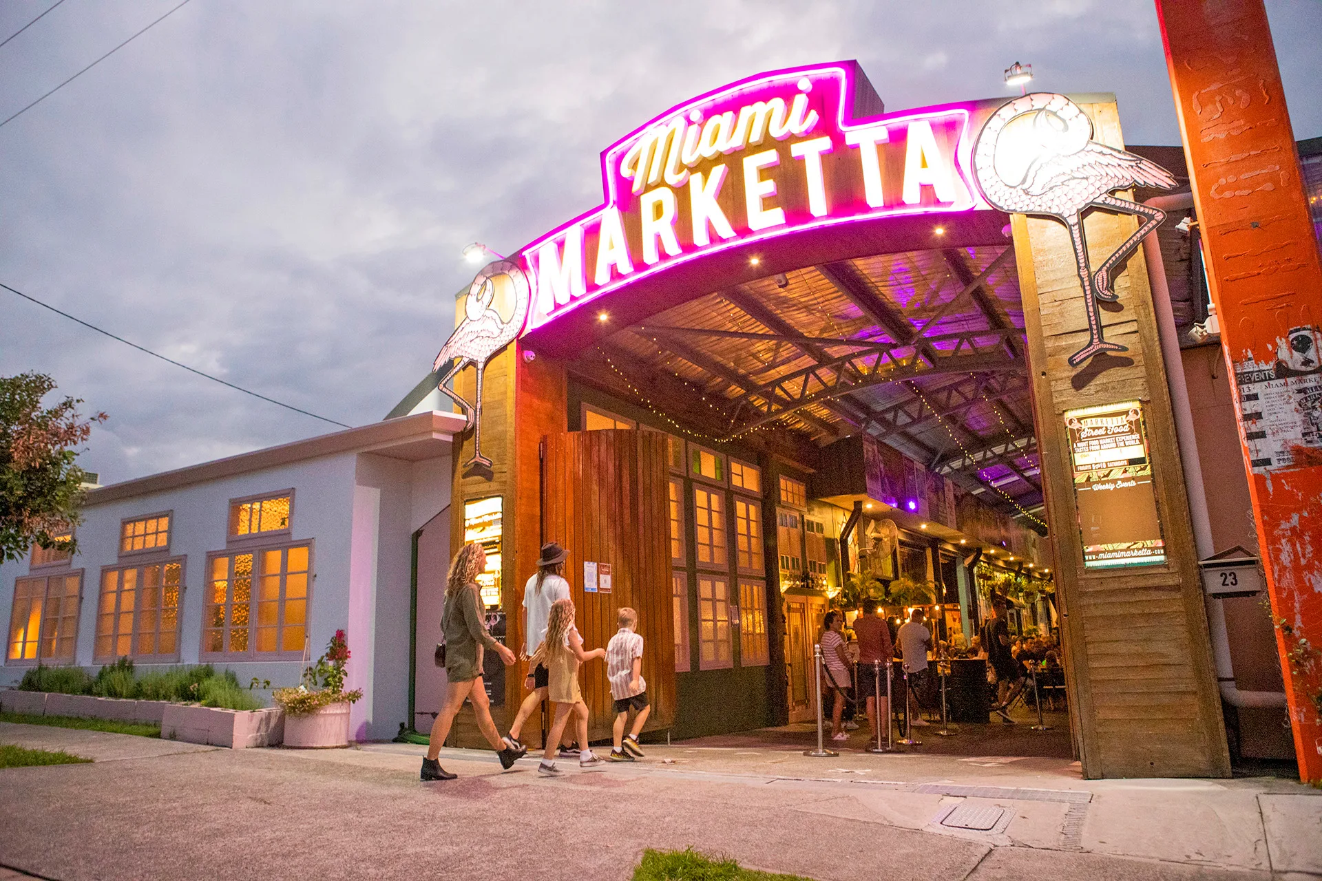 Family walking through entrance of Miami Marketta