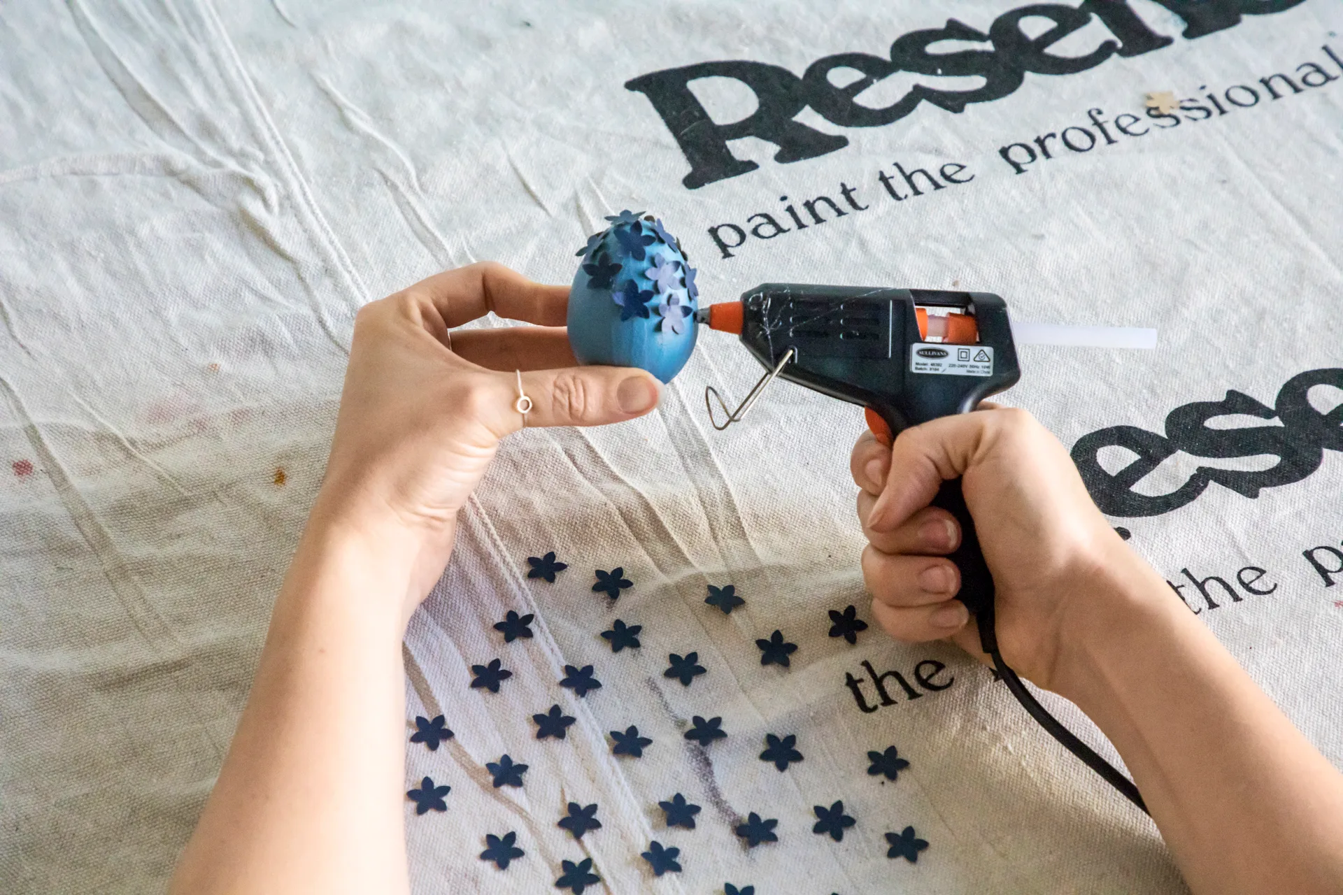 Hot glue gunning shapes on egg