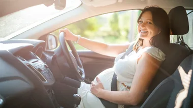 Pregnant woman driving the car