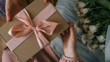 Person's hands handing a present over to another person