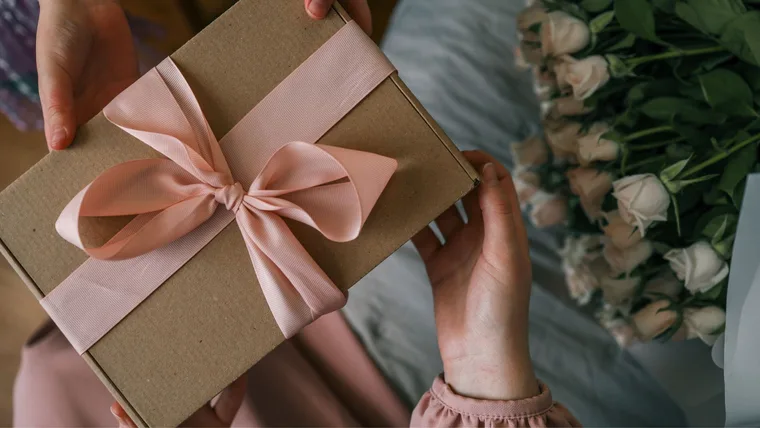 Person's hands handing a present over to another person