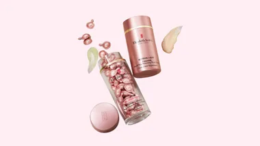 Elizabeth Arden Retinol Ceramide capsules and cream on a pink background.