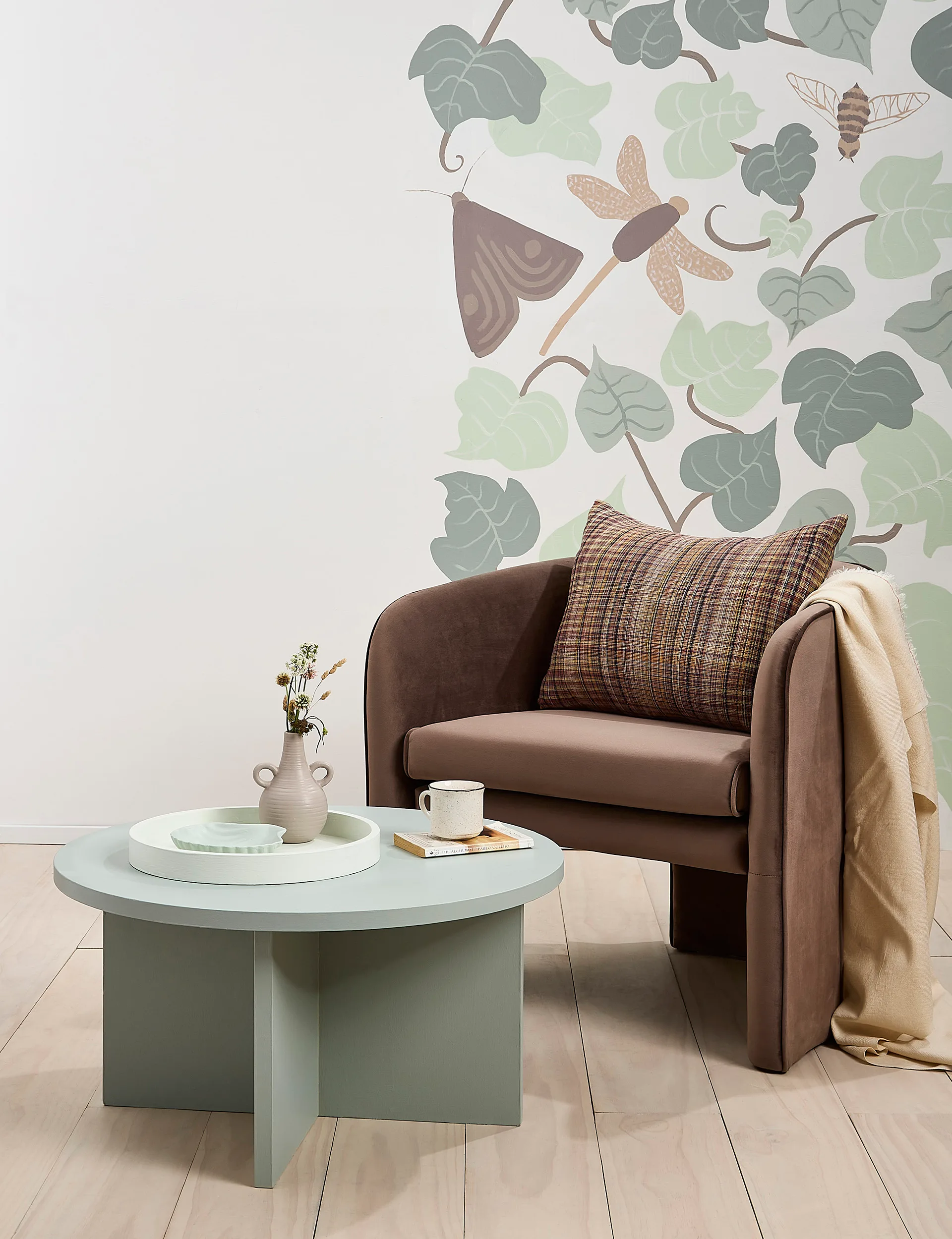 Brown chair, green coffee table, mural wall using eco-friendly paint