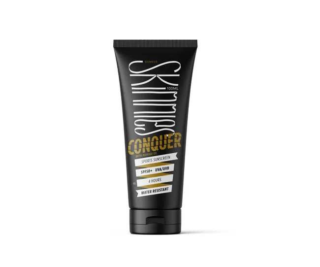 Black tube of Skinnies Conquer Sports Sunscreen SPF50+, 100ml, with Manuka oil; water-resistant for 4 hours.