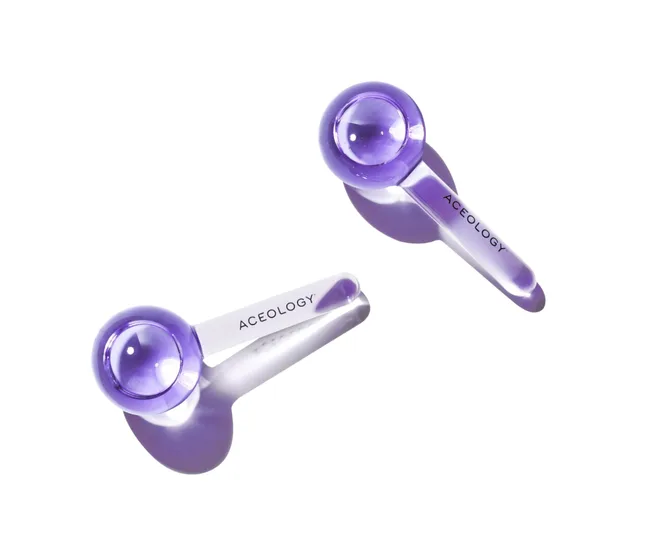 Two purple facial globes by Aceology with transparent handles, titled "ACELOGY."