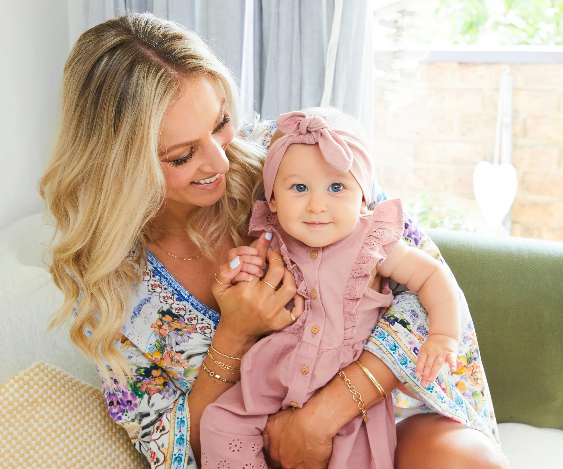 Mum holding a beautifully dressed in pink Andie Lee
