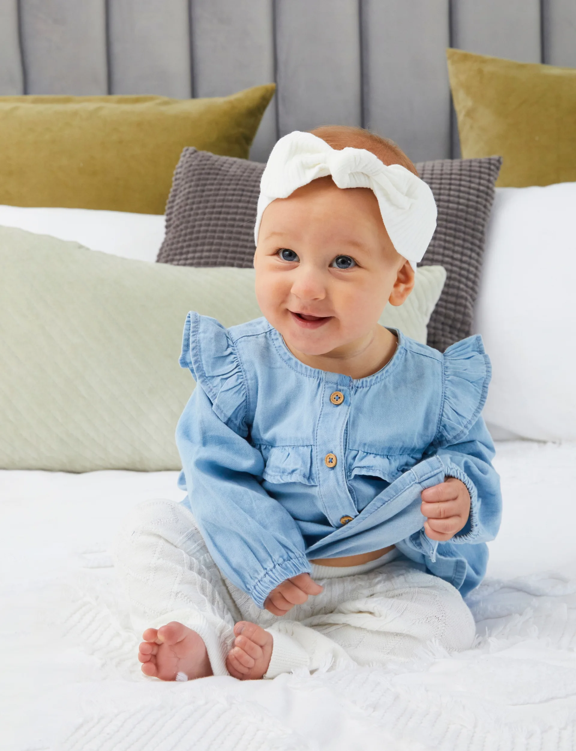 Baby Andie Lee Bayer sitting on a bed on her own!