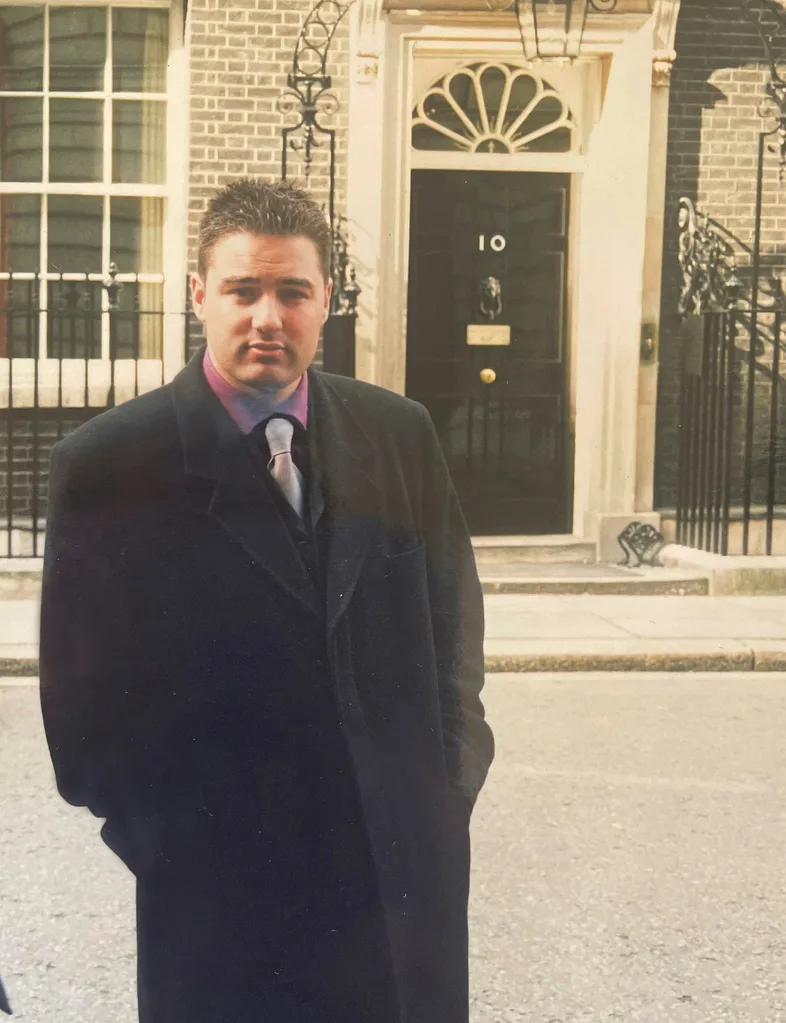 Young Duncan standing in front of the 10 Downing Street door in London.