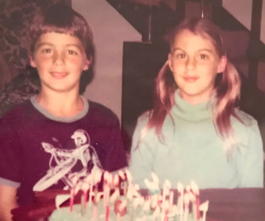 Duncan and twin sister Rachel sitting in front of a birthday cake