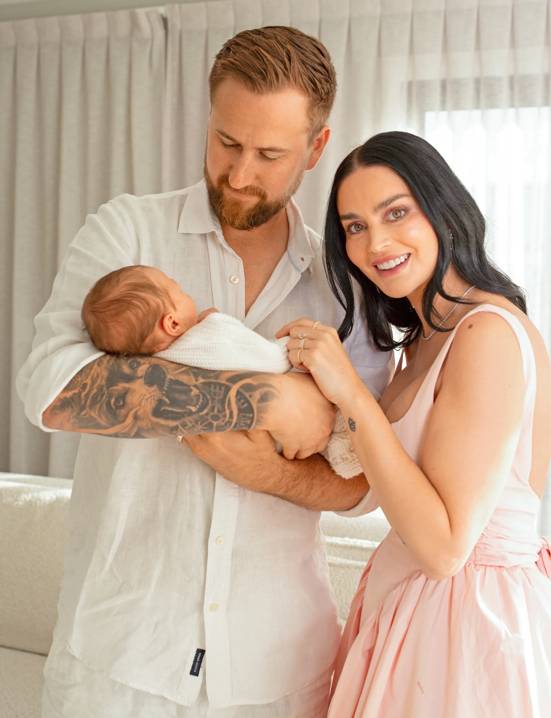 Edna Swart standing with husband Reid while he holds baby Astyn