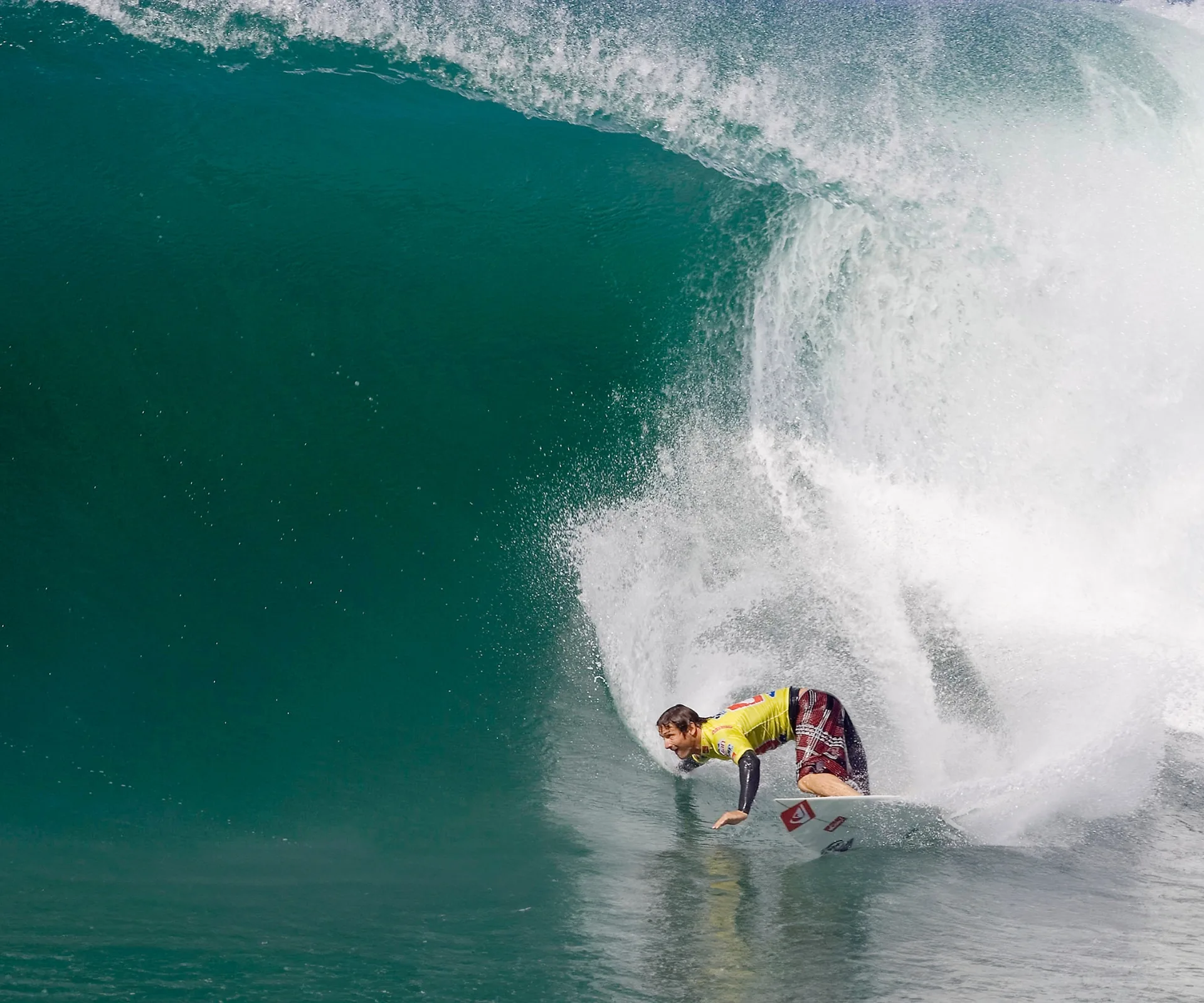 Maz Quinn surfing on a wave at least triple his height before his accident