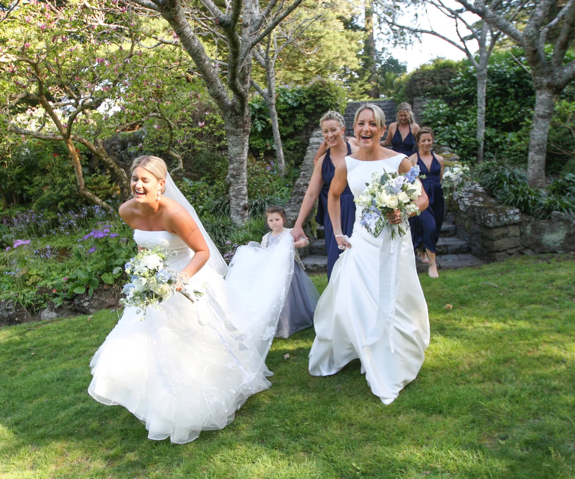 Izzy Fenwick and partner Rowan running in their wedding dresses