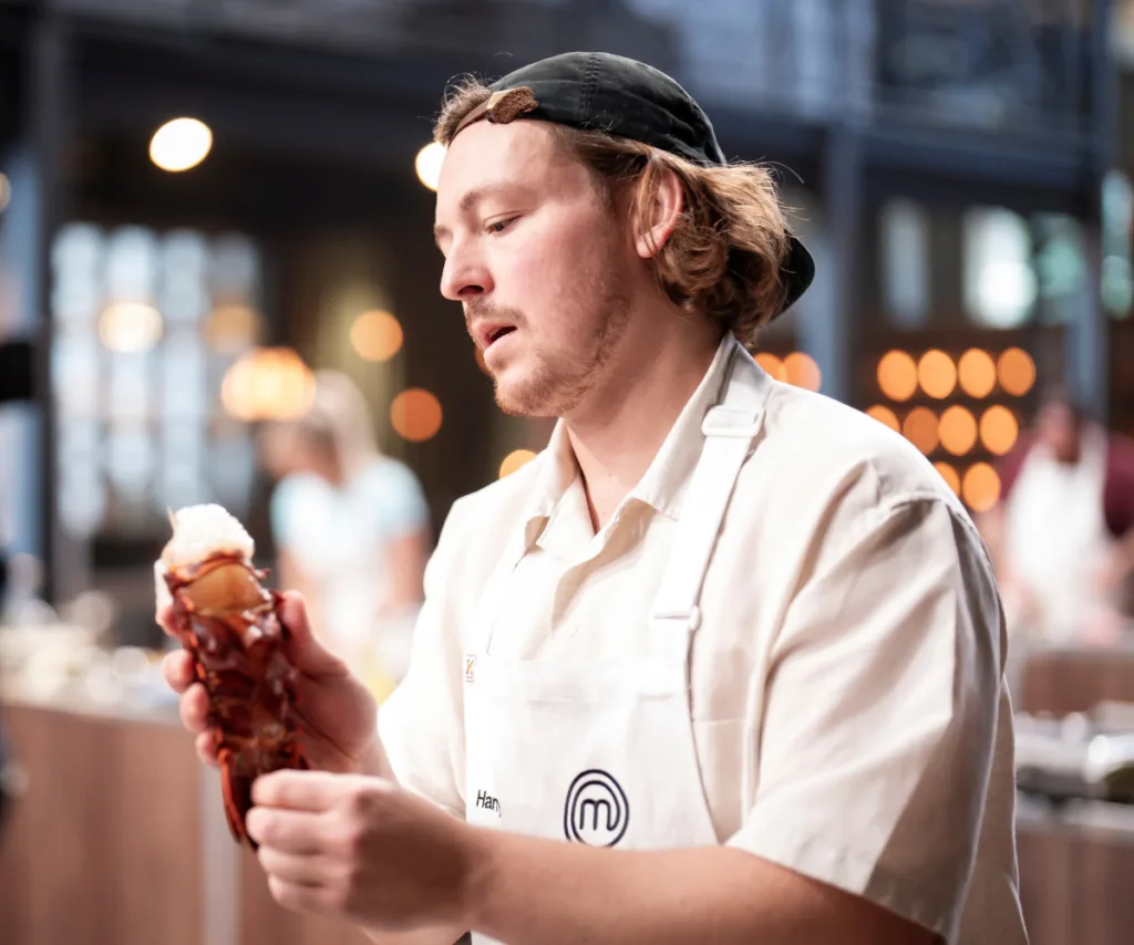 Harry Butterfield working on a lobster tail on set of MasterChef