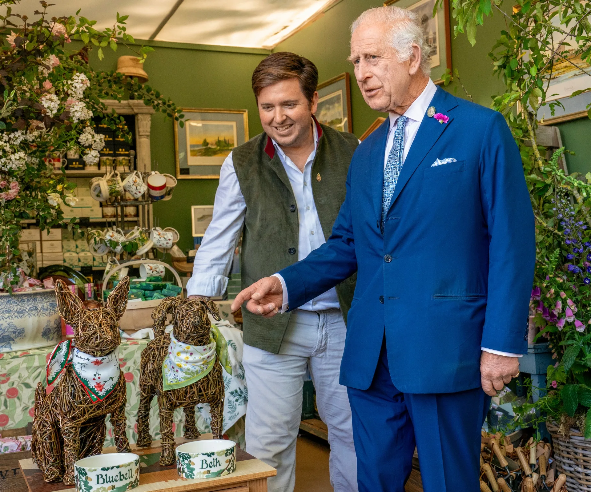 Like the princess, King Charles also has Cancer. He is pictured here looking at two dogs made out of sticks