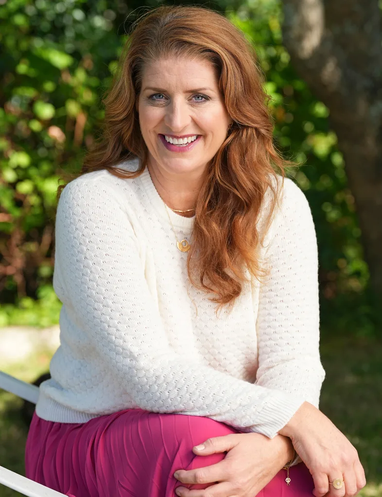 Francesca Rudkin in a pink skirt and white knit top