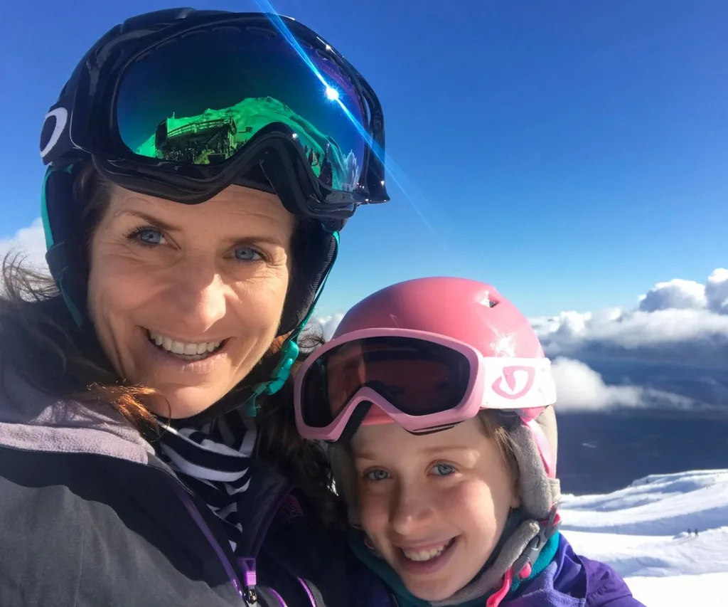 Francesca Rudkin on a snowy mountain in Skiing gear with daughter Lola