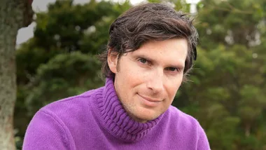 Sam Bunkall in a purple turtleneck