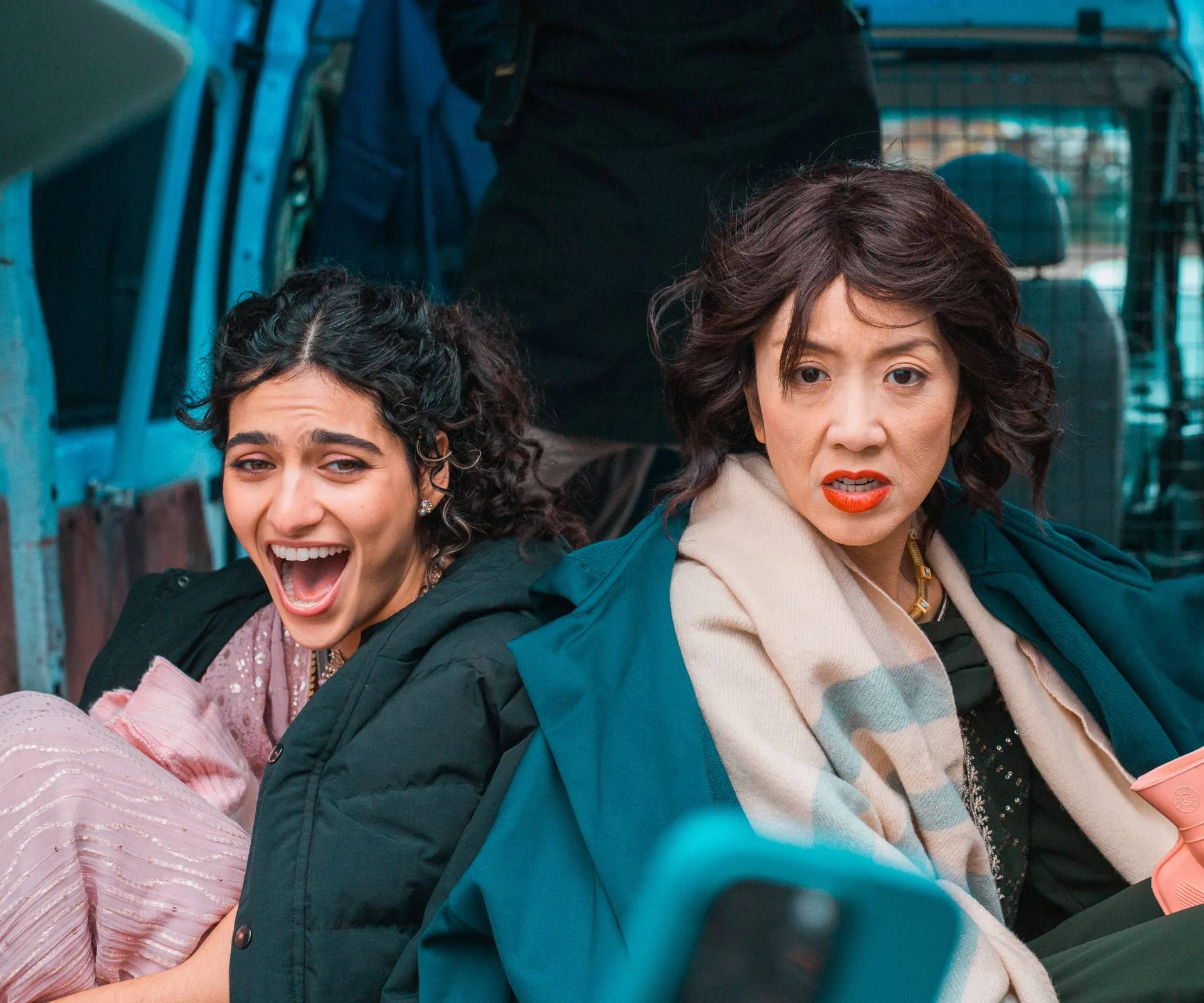 Actresses reacting shocked to something they're being shown on an iPhone