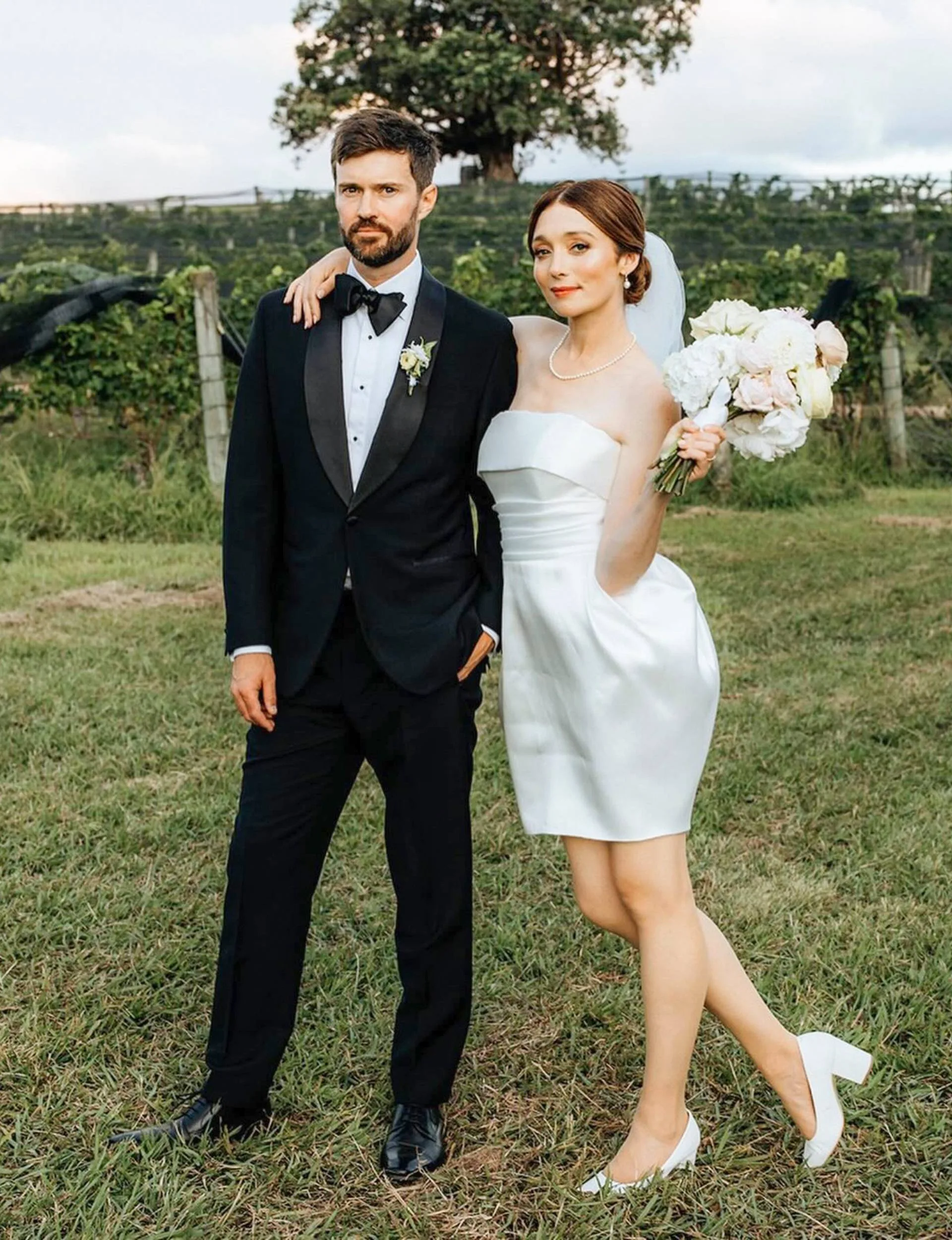 Antonia and Dan pose for the camera at their wedding