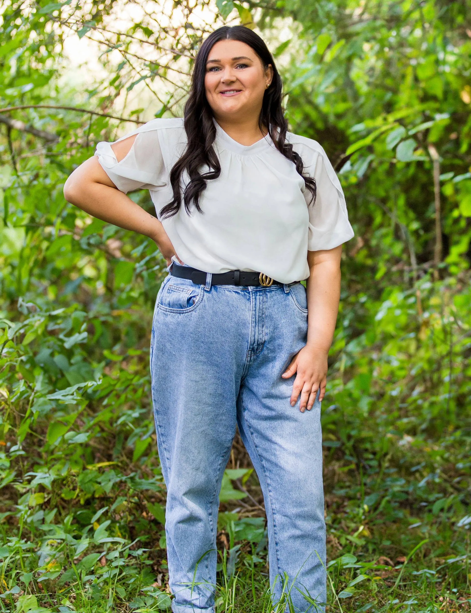 Brooke standing in front of a bush