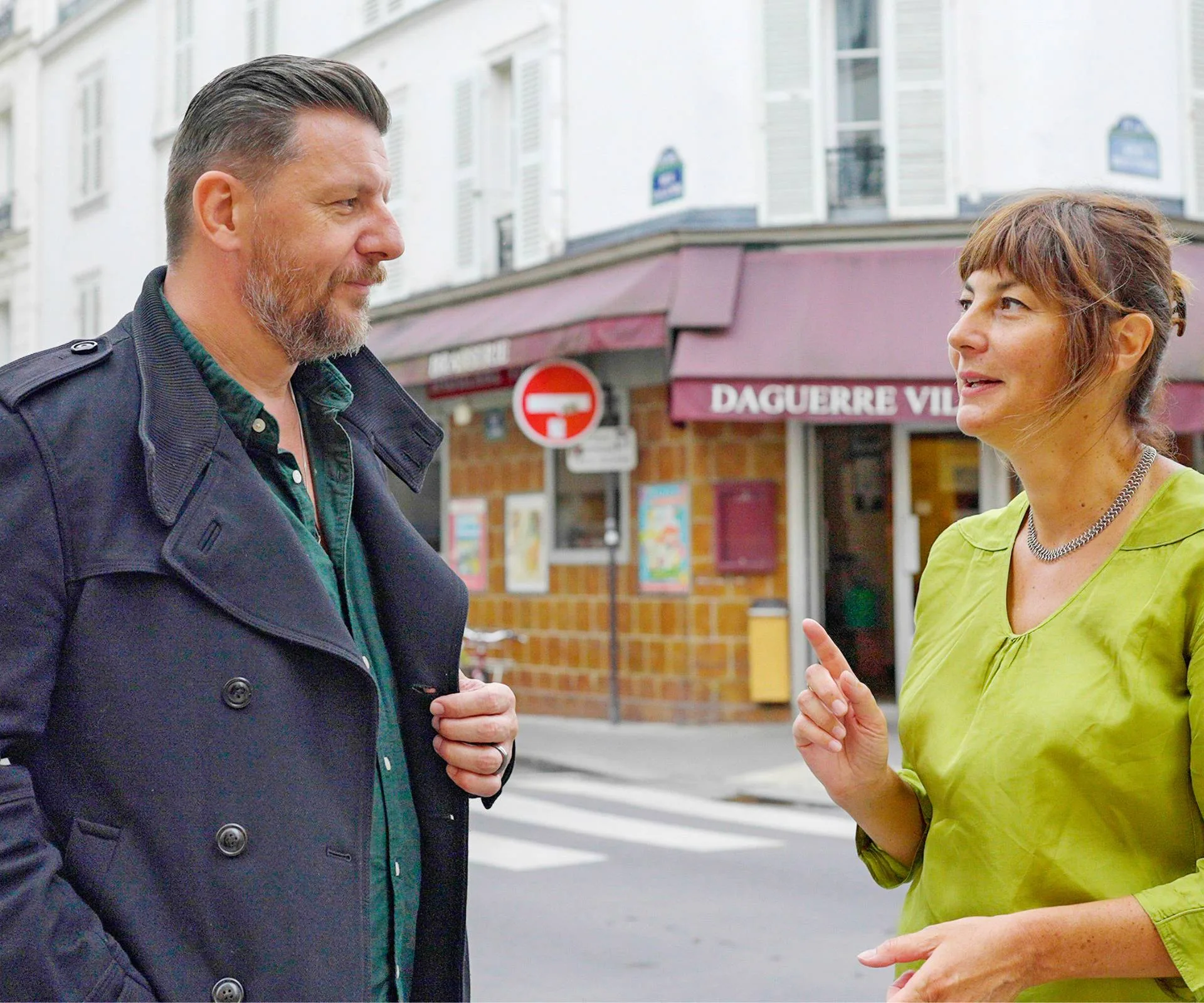 Manu Feildel talking to a show presenter on the corner of a street
