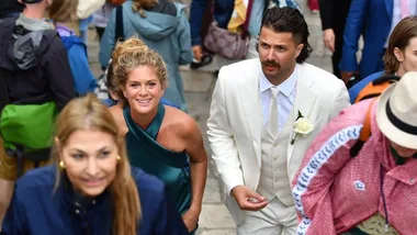 Rachel Hunter ascending stairs with son Liam at his wedding