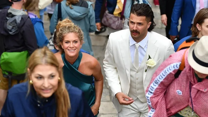 Rachel Hunter ascending stairs with son Liam at his wedding