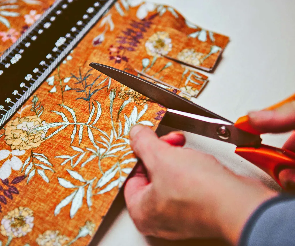 Scissors cutting the tassels into the fabric