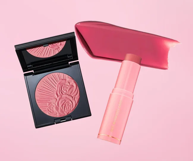 Pink blusher palette with rose engravings and a matching pink lipstick tube against a soft pink background.