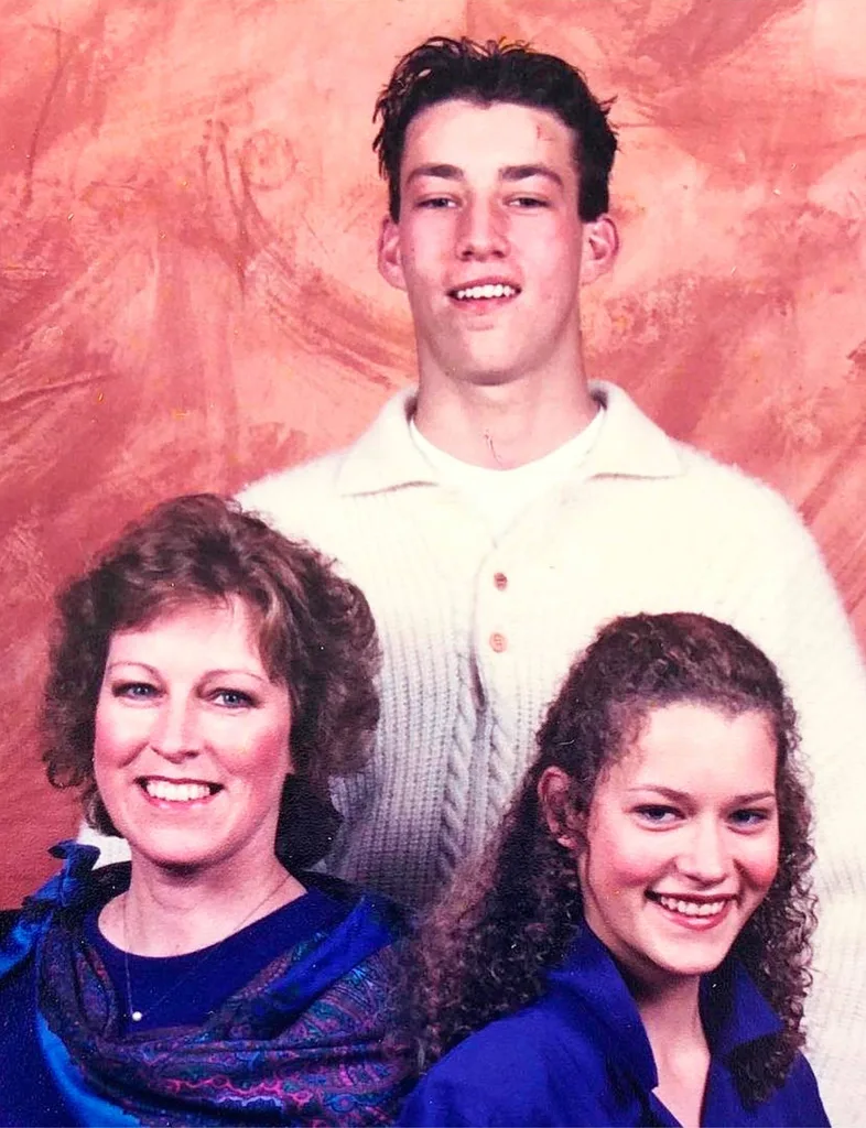 Aaron standing behind his bother and sister in the '80s